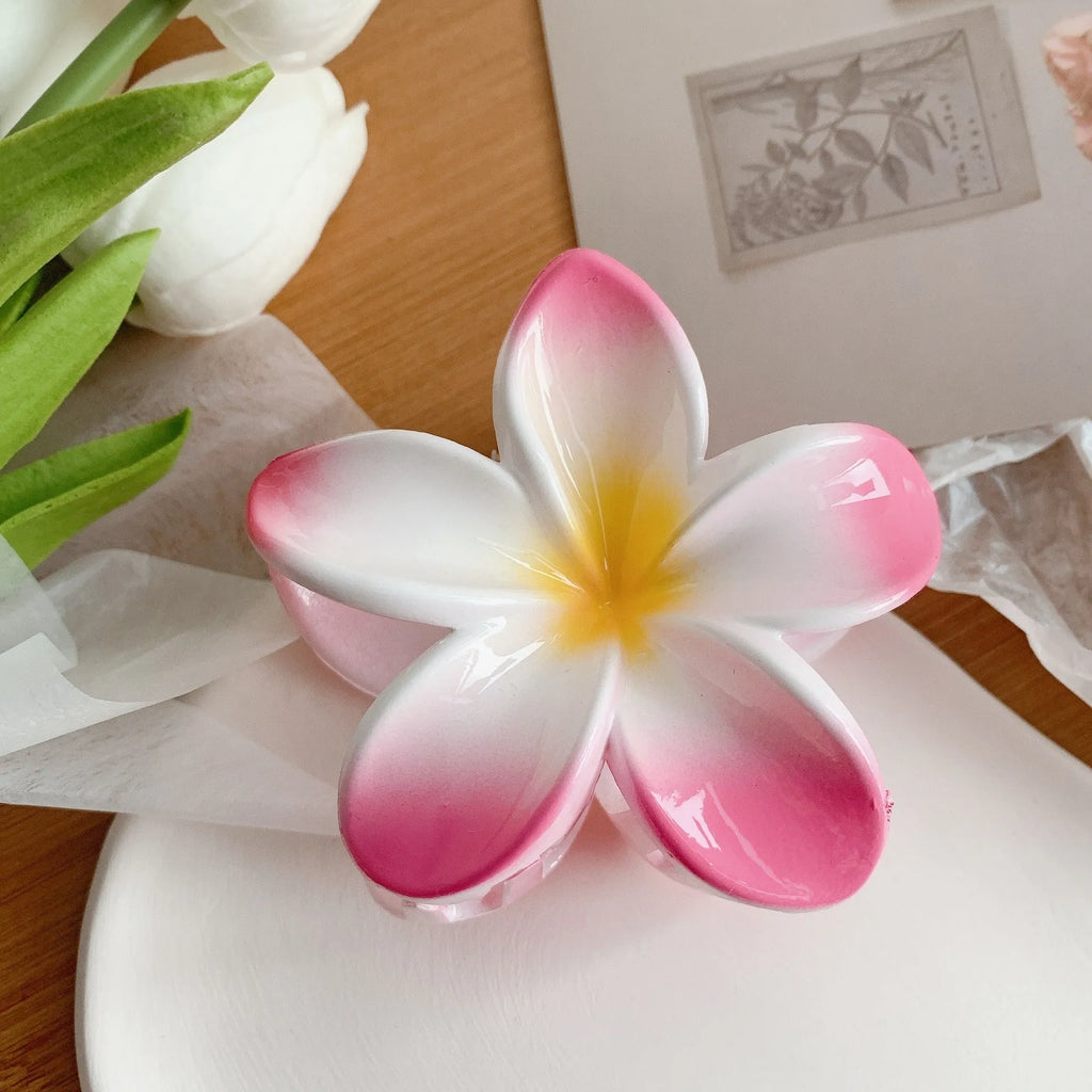 Muweordy plumeria hair claw clip in blue, a decorative flower hair accessory made from plastic and resin.