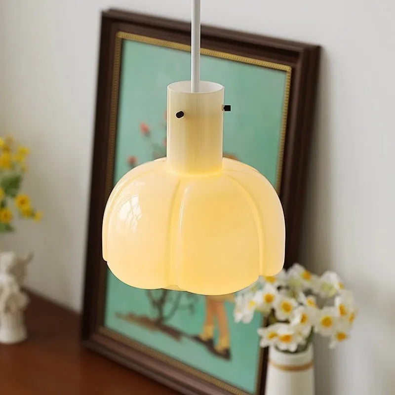 Close-up of a retro medieval-style glass bud chandelier pendant light with a warm glow.