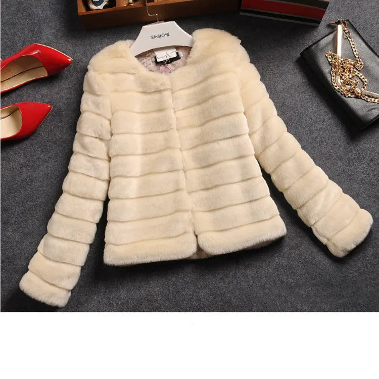 A woman wearing a short white faux fur top with regular sleeves, layered over a black long-sleeve top.