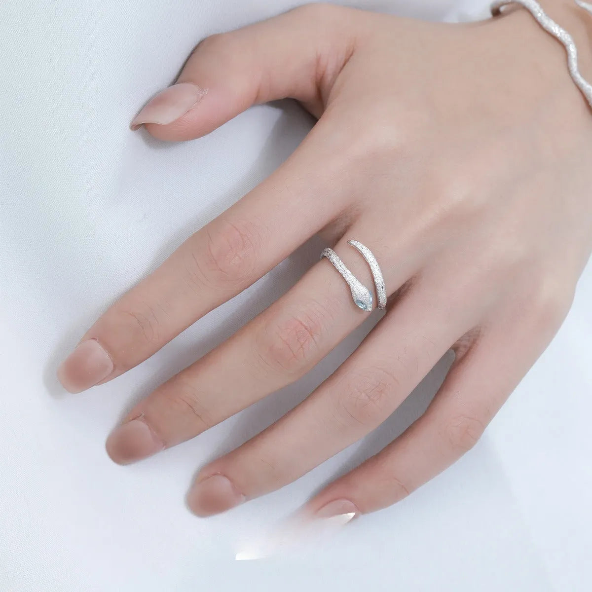 Adjustable silver snake ring with electroplated platinum colour finish and zodiac design