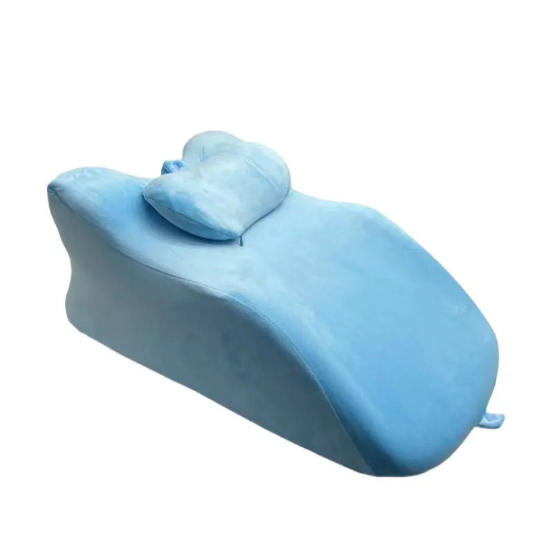 Stomach sleeper pillow in blue designed for front-lying positions, reading support, and phone use