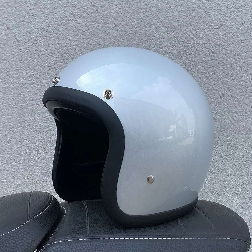 Retro-style motorcycle half helmet in cement grey with a glossy fibreglass shell on a plain background.