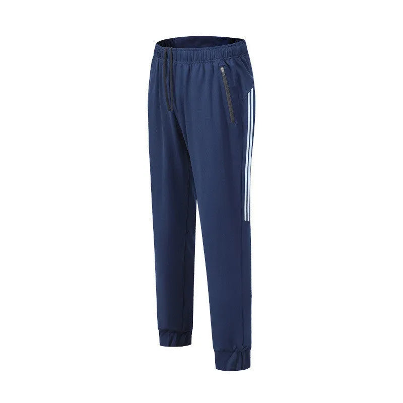 Black men's running trousers with a mid waist, laid flat to show the trousers length and sporty design.