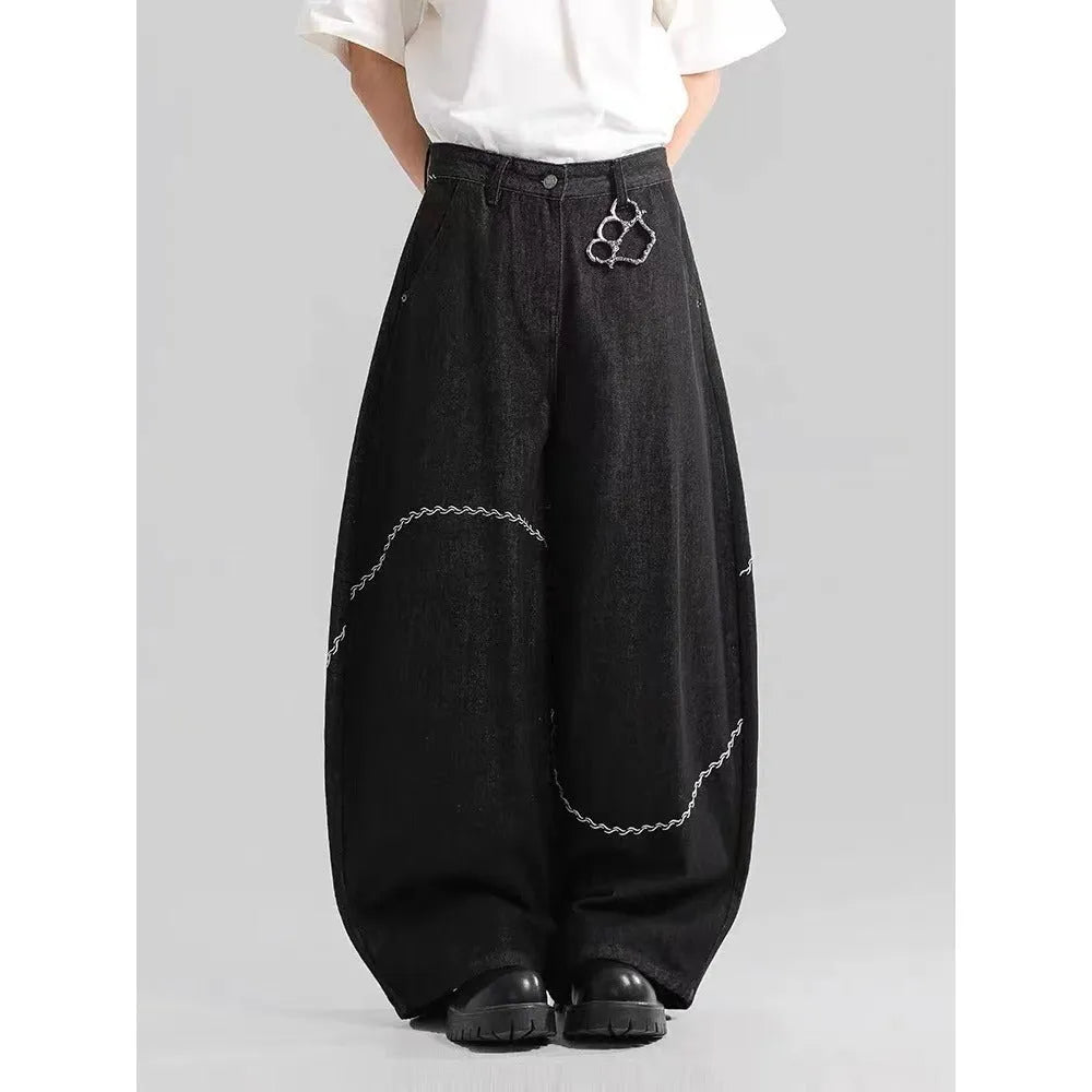 Black straight-leg denim trousers with a mid-waist fit and micro-elastic waistband on a hanger.