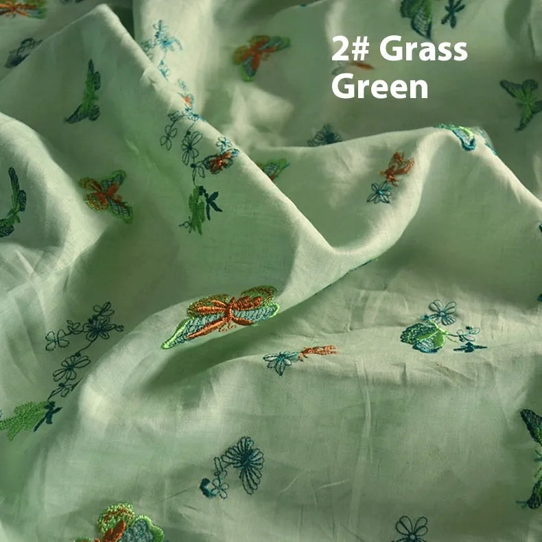 A piece of pure ramie fabric in beige, dark green and grass green, showing its texture and 140cm width.