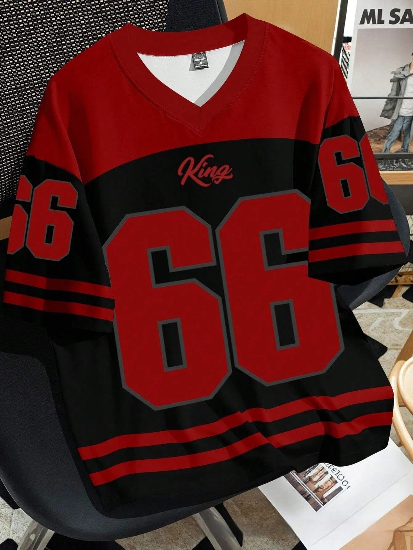 Man wearing a loose grey t-shirt with a large Chicago No. 23 digital print on the front.