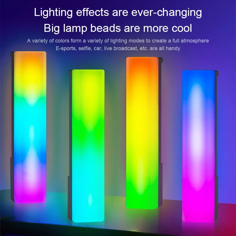 A tall, colourful RGB table lamp with a white or black shell reacting to sound on a desk.