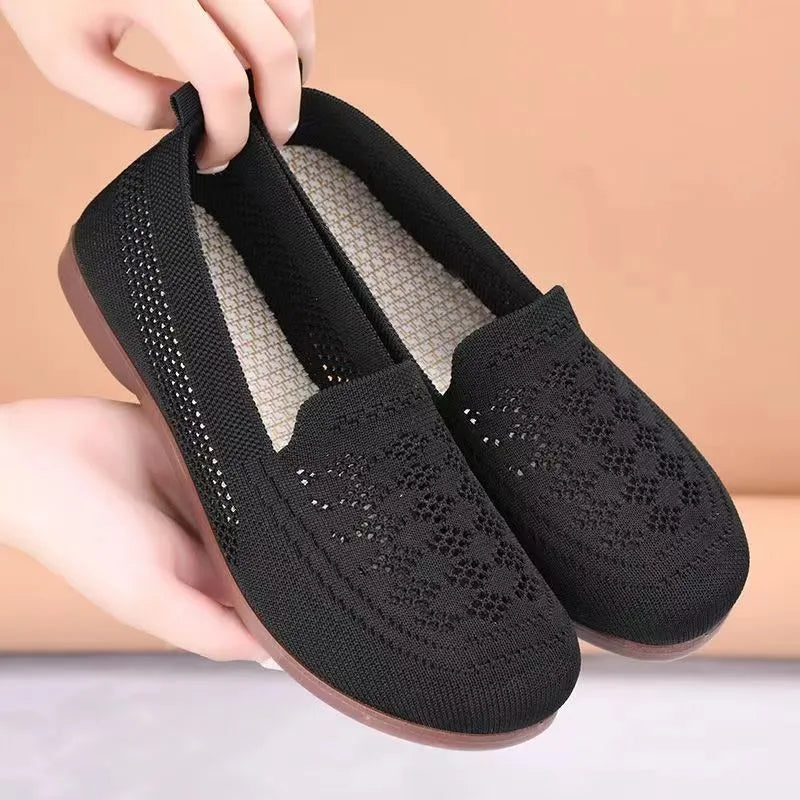 Beige casual tennis shoes for women with mesh upper and antiskid sole on a plain background.