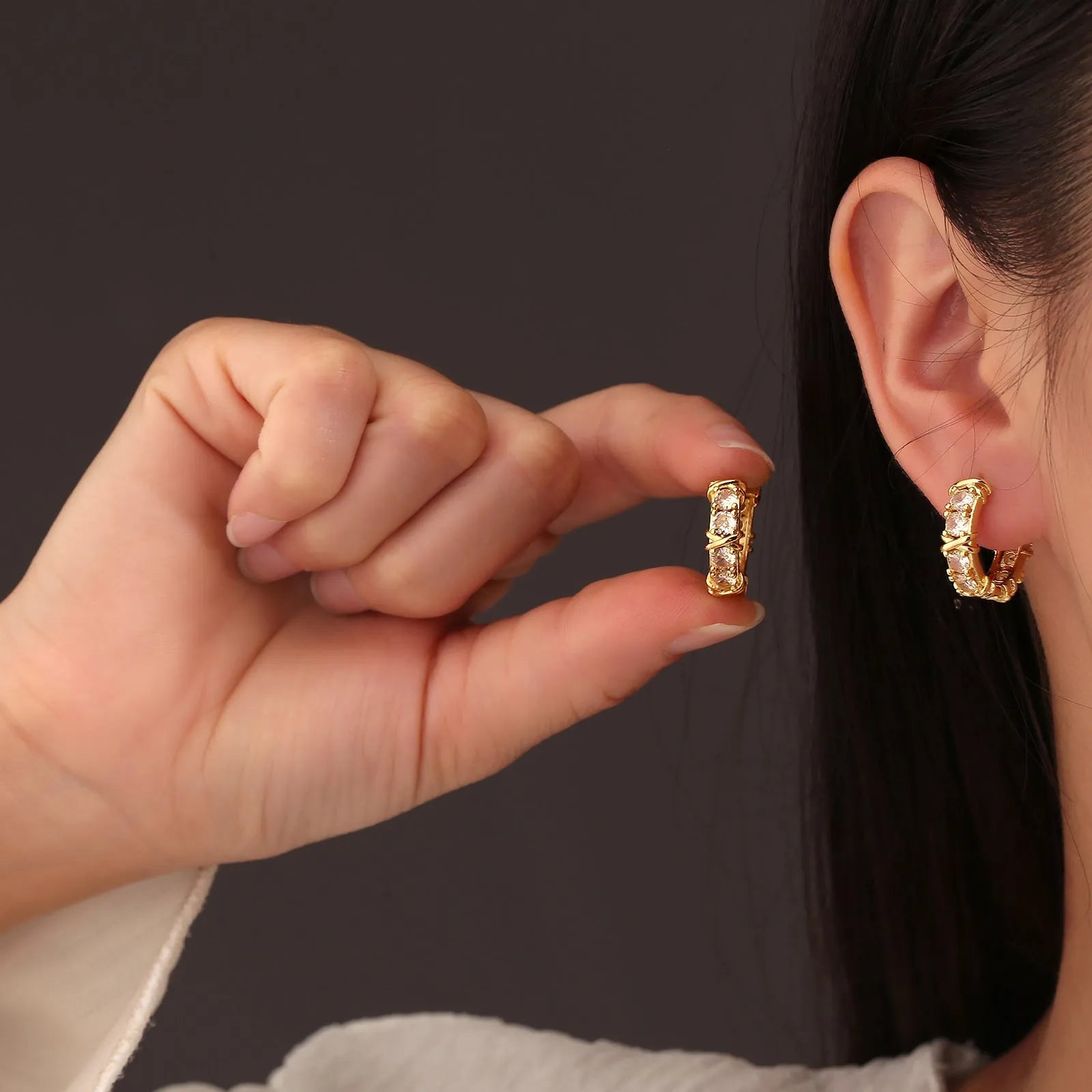 A pair of women's hexagonal geometric earrings with a clover cross design in silver or gold colour.