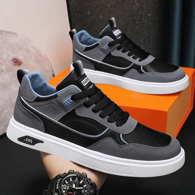 Men's beige low-top canvas board shoes with leather stitching details on a white background.