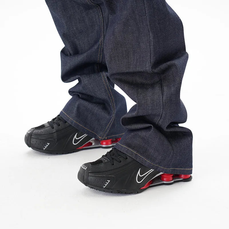 Man's dark blue loose straight-leg casual jeans on a white background.