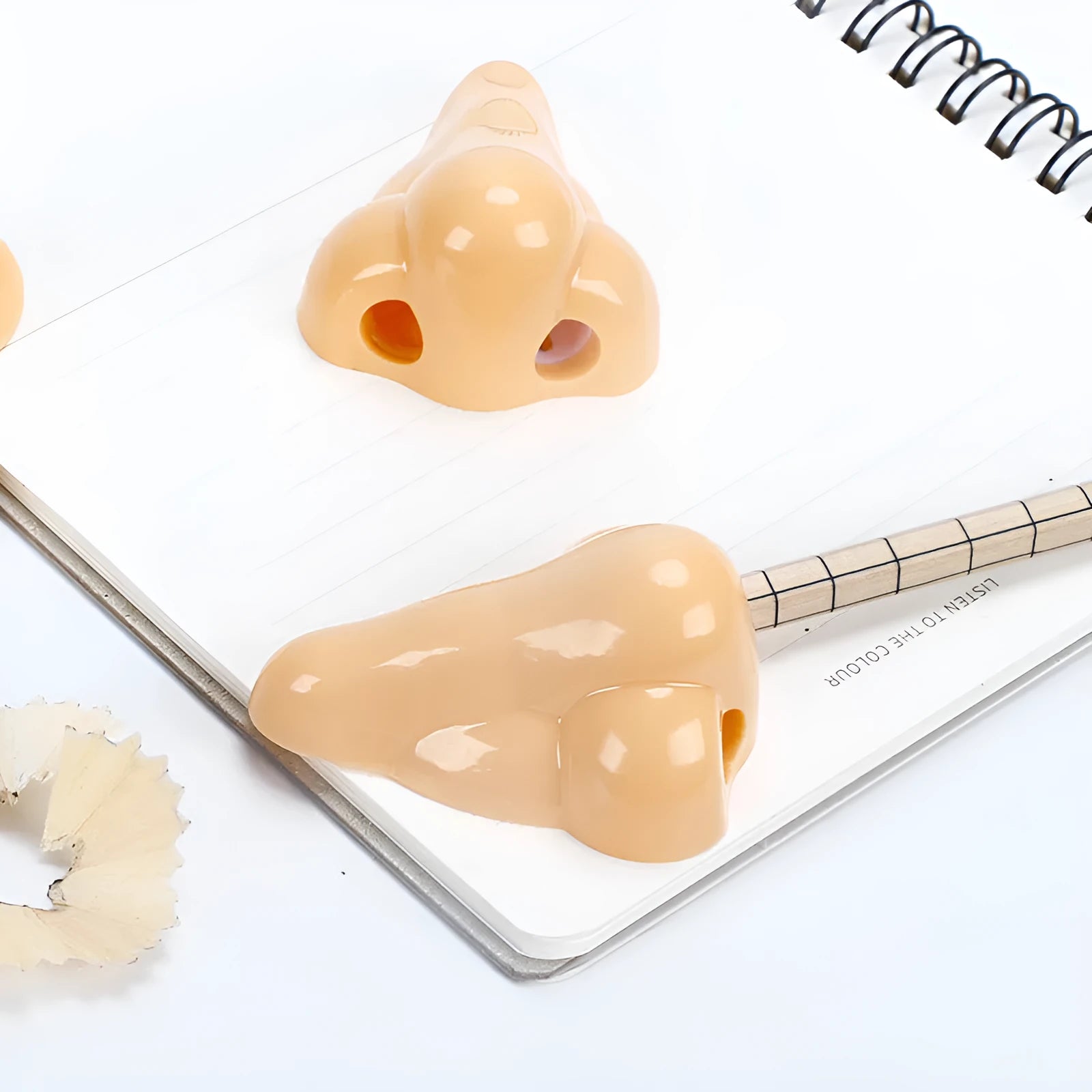 Flesh colour plastic geometry-shaped pencil sharpener with large sharpening holes.