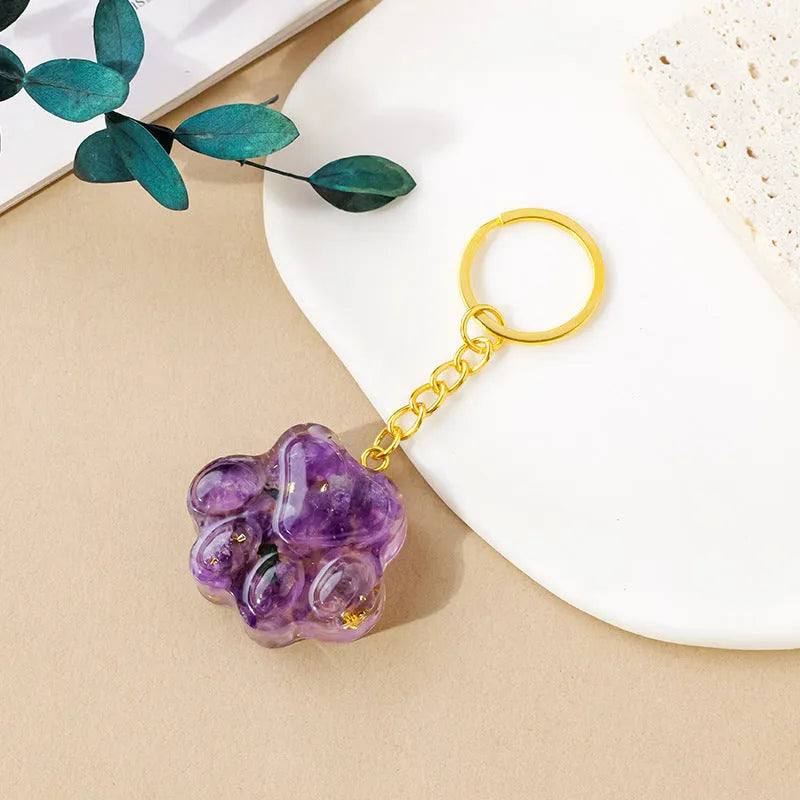 Small natural crystal cat's paw pendant on a metal keyring, available in various stone colours.