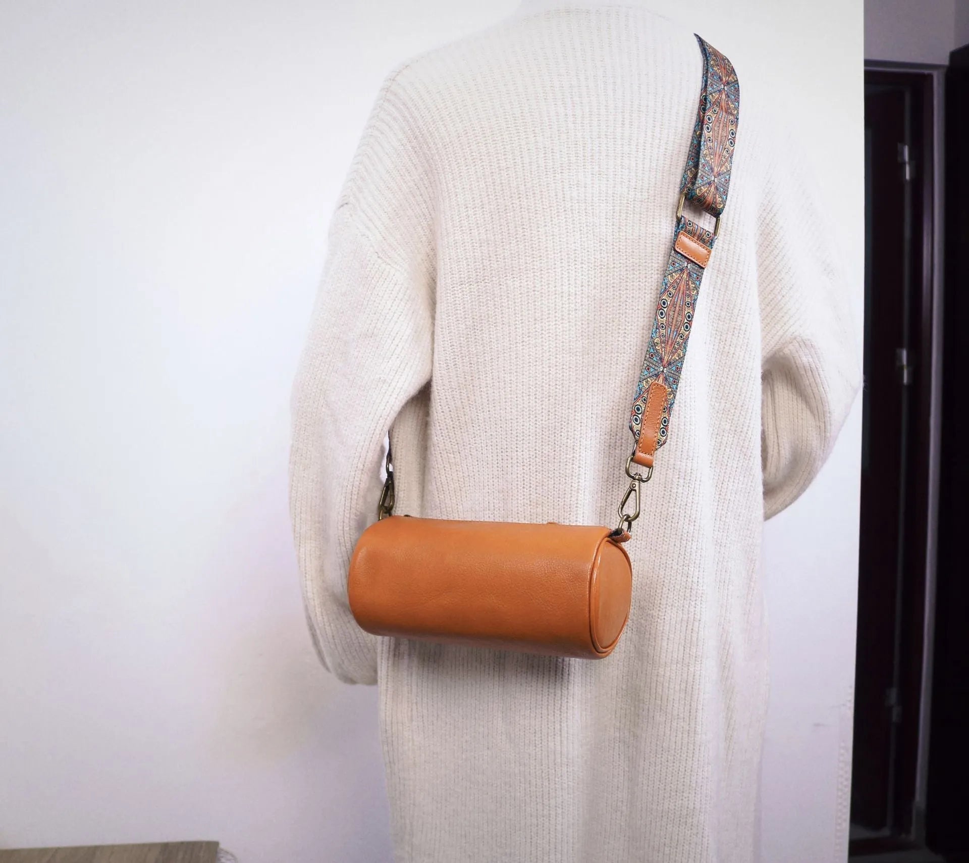 Top layer cowhide leather round single-shoulder bag in caramel brown with wide strap and sewing thread details