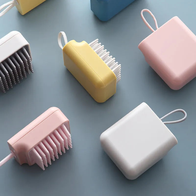 Pet bath brush with soft TPR combs for dog and cat grooming, available in blue, pink, white, and yellow.