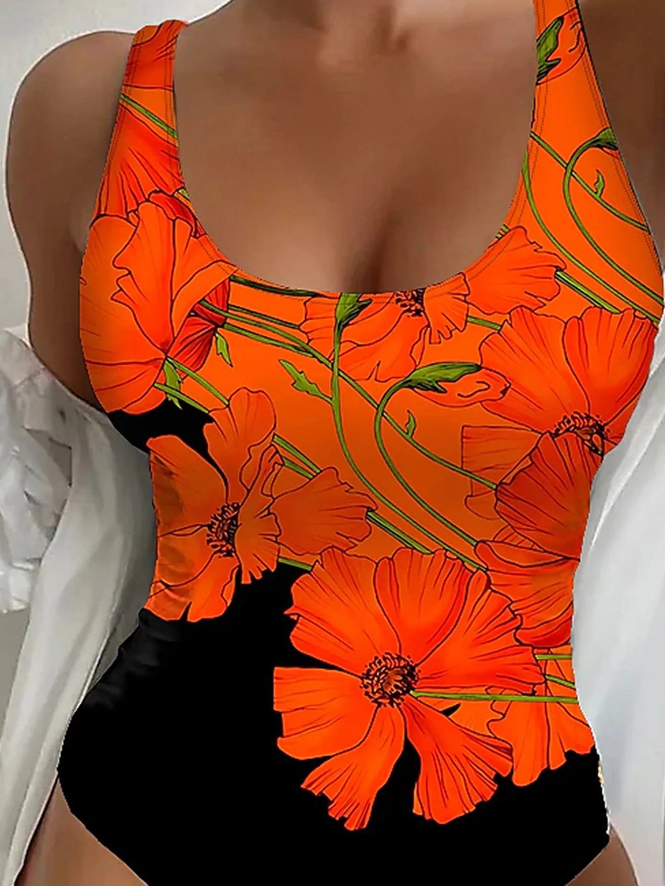 Orange floral print backless one-piece swimsuit with slim fit design on mannequin
