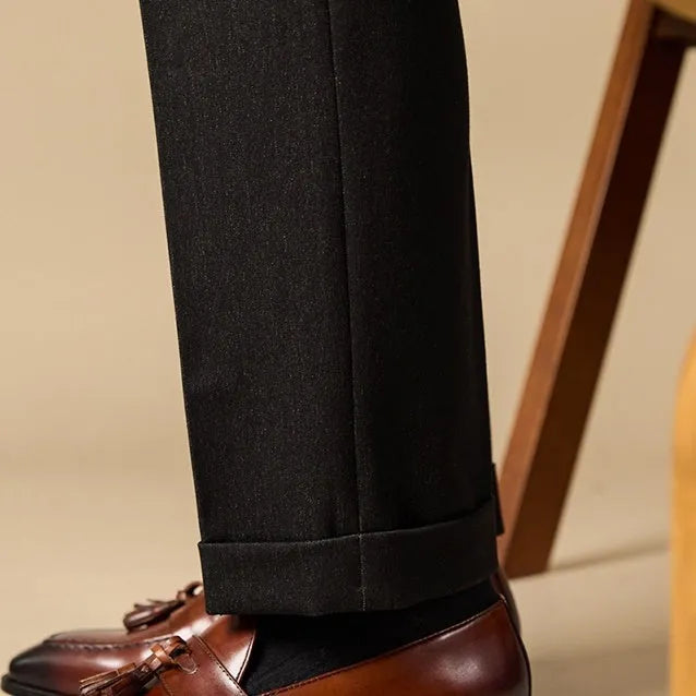 Men's black genuine leather tassel loafers with a polished finish and rubber sole.