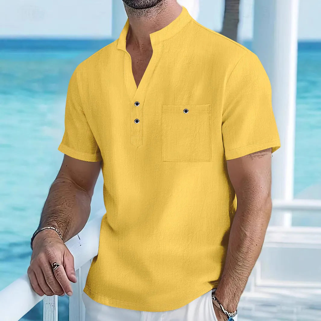 Man wearing a light-coloured linen blend T-shirt with a stand collar and short sleeves.