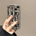 Silicone iPhone 17 phone case with water ripple texture in green, shown fitted to a phone.
