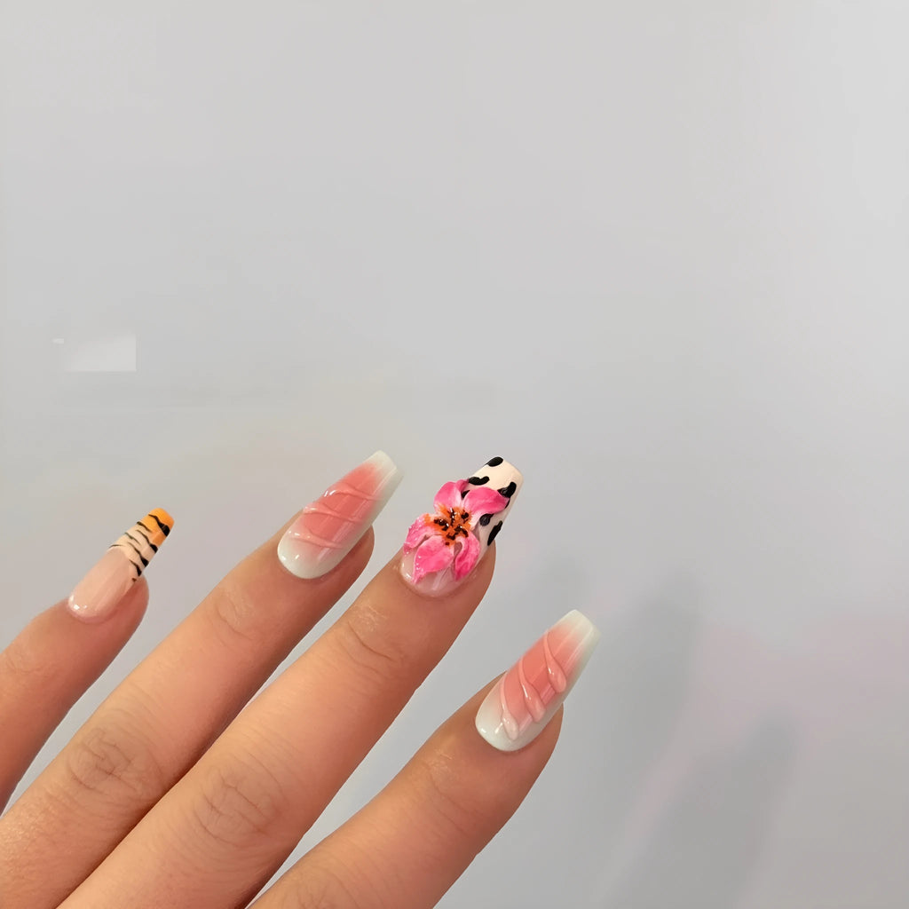 Hand-carved false nails with zebra pattern and lily designs in sizes XS through L