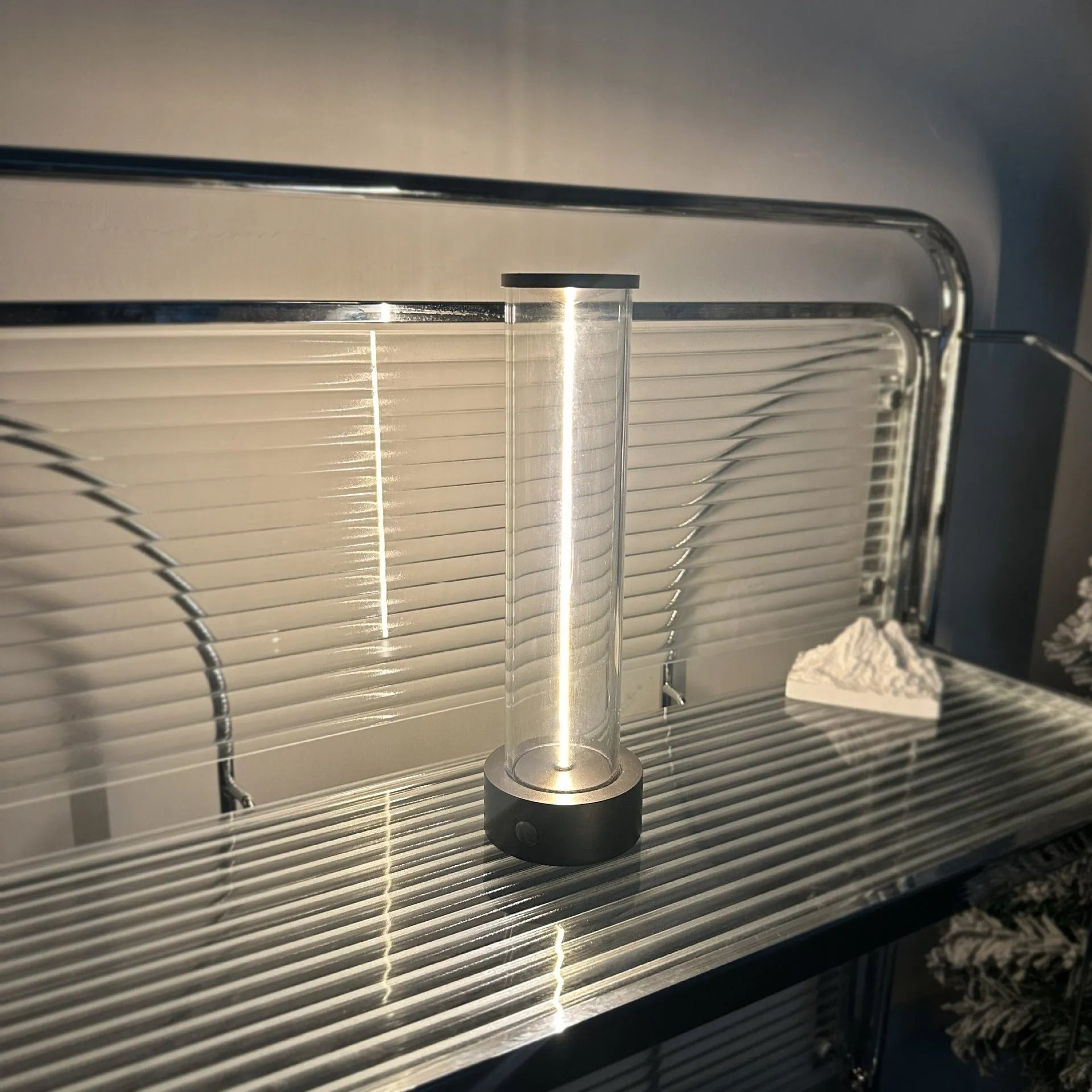 Slim modern glass LED bar night light with magnetic base on a desk surface.