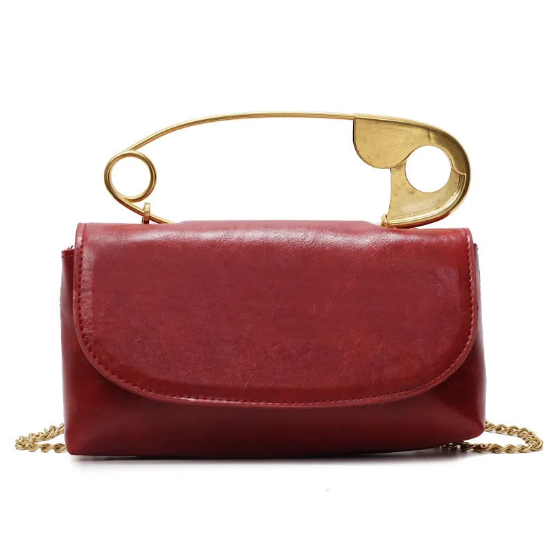 Creative personality paper clip shoulder handbag in PU leather with sandwich pocket and file bag interior.