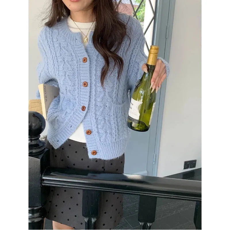 Solid colour thick needle twisted texture knitted cardigan in beige, short length, on model