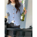 Solid colour thick needle twisted texture knitted cardigan in beige, short length, on model