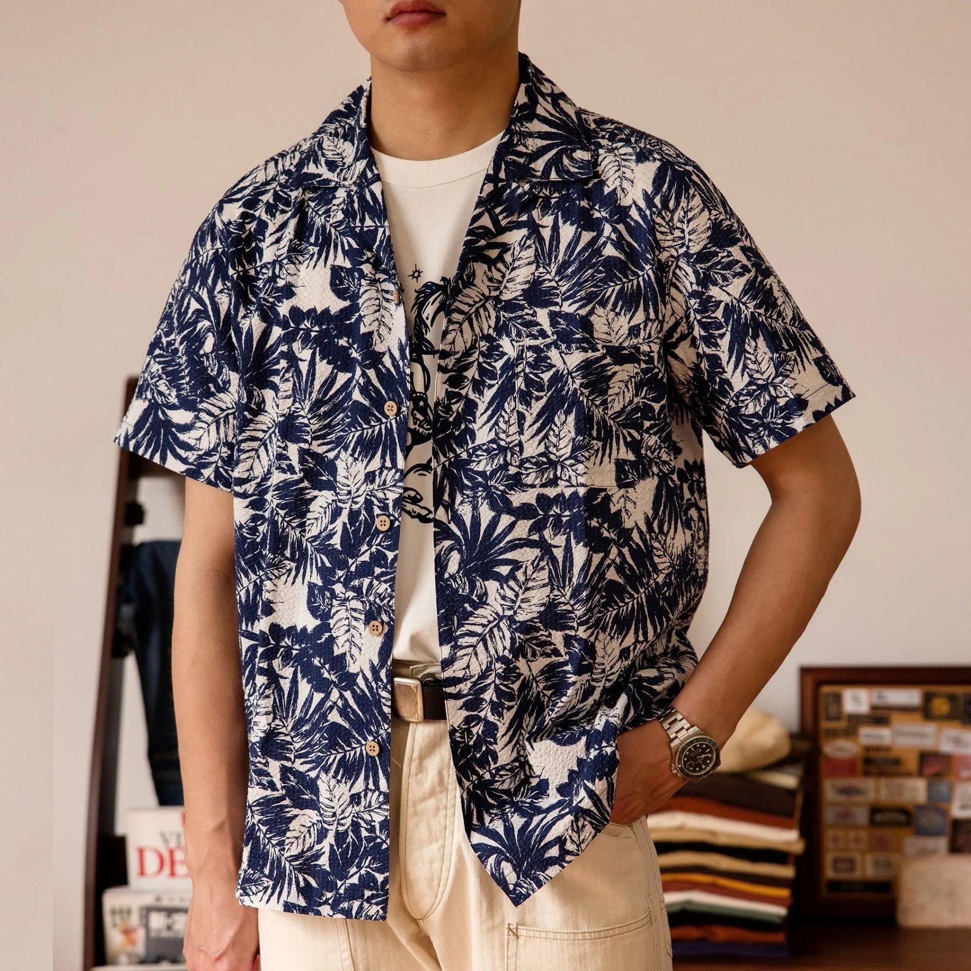 Vintage floral print seersucker shirt with a Cuban collar on a mannequin, shown in blue and green.