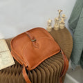 Brown genuine leather messenger bag with flap closure and crossbody strap showing internal organiser compartments
