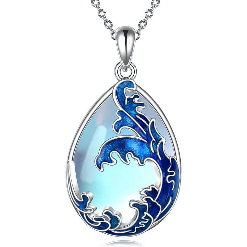 Close-up of a moonstone blue heart-shaped alloy pendant on a women's necklace chain.