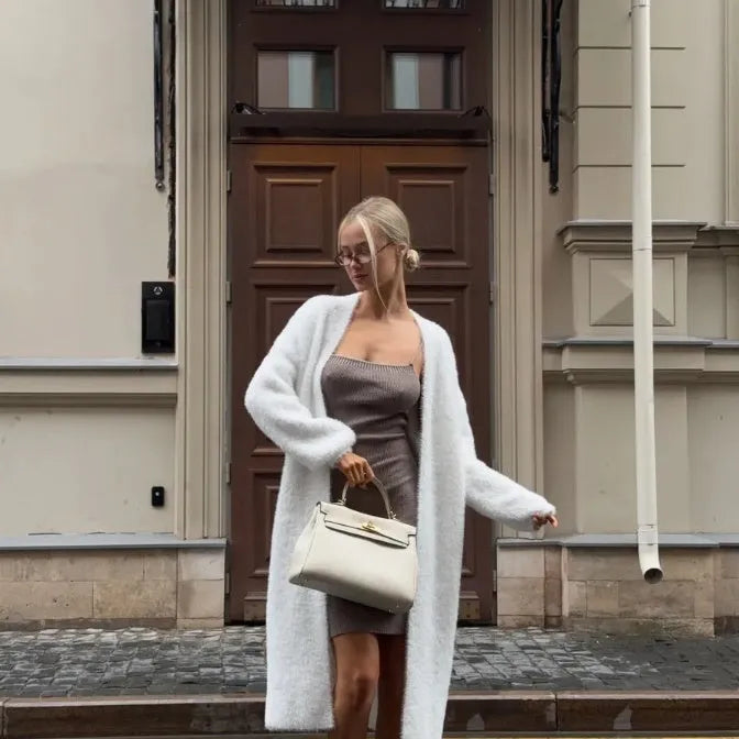 White knitted women's cardigan jacket with long sleeves and a loose, free-size fit