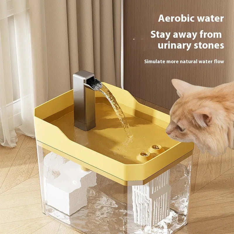 Automatic cat water fountain with filter in transparent plastic, showing water flow.
