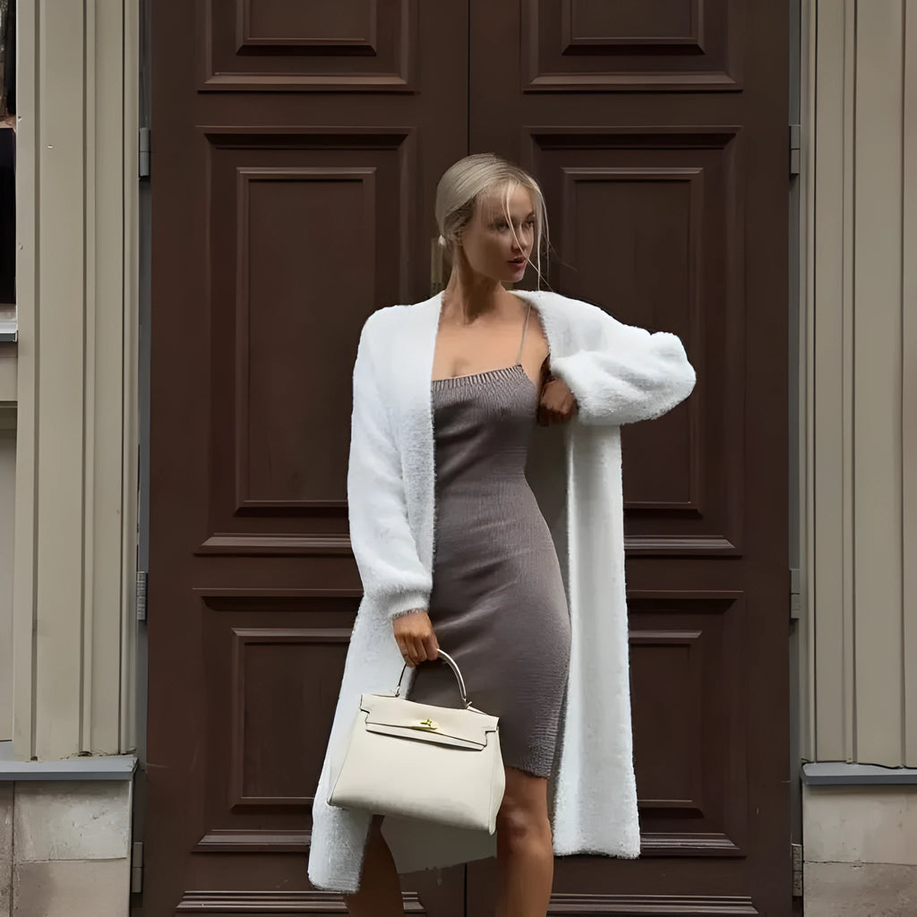 White knitted women's cardigan jacket with long sleeves and a loose, free-size fit