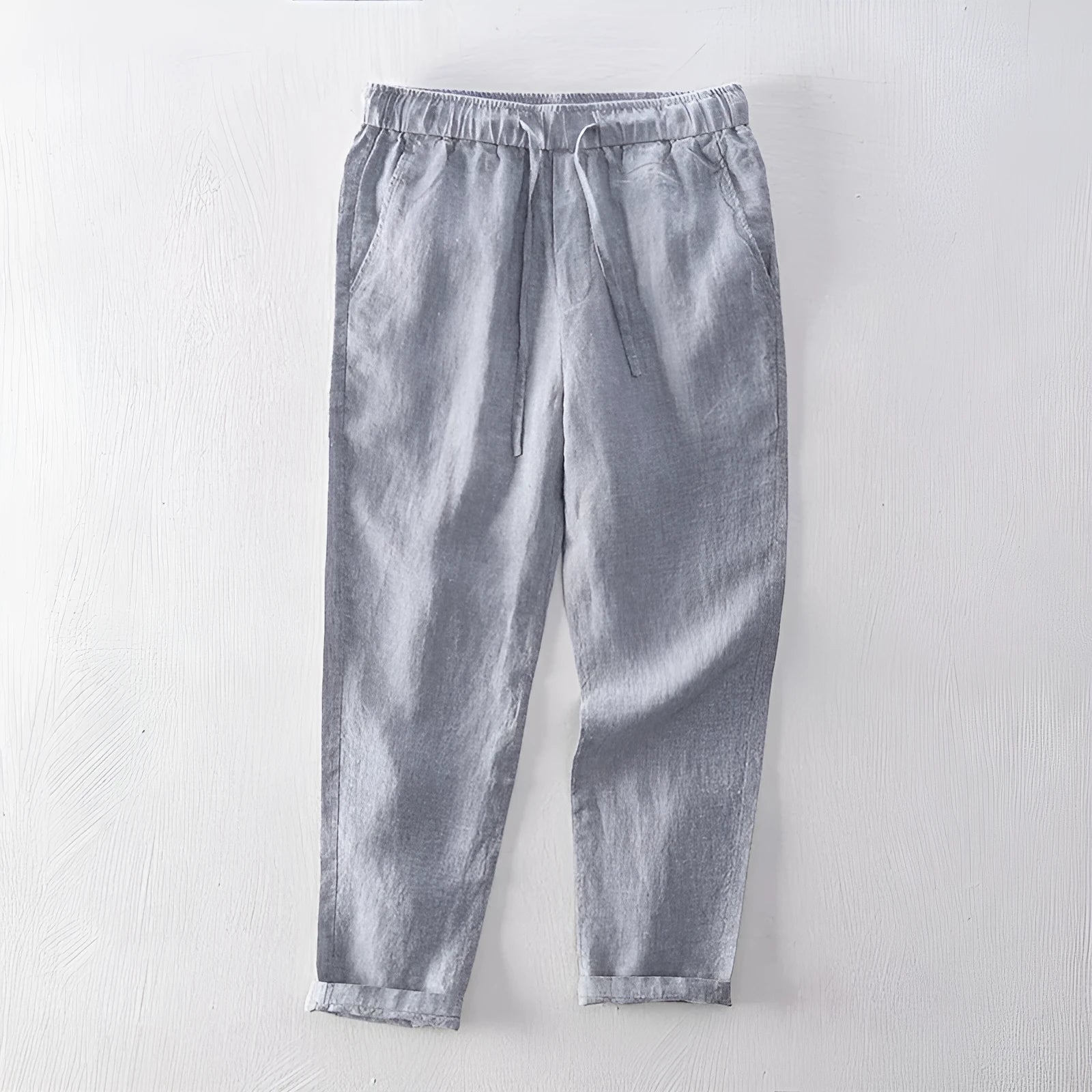 Men's straight-leg linen trousers in a mid waist cut, shown in a neutral colour.
