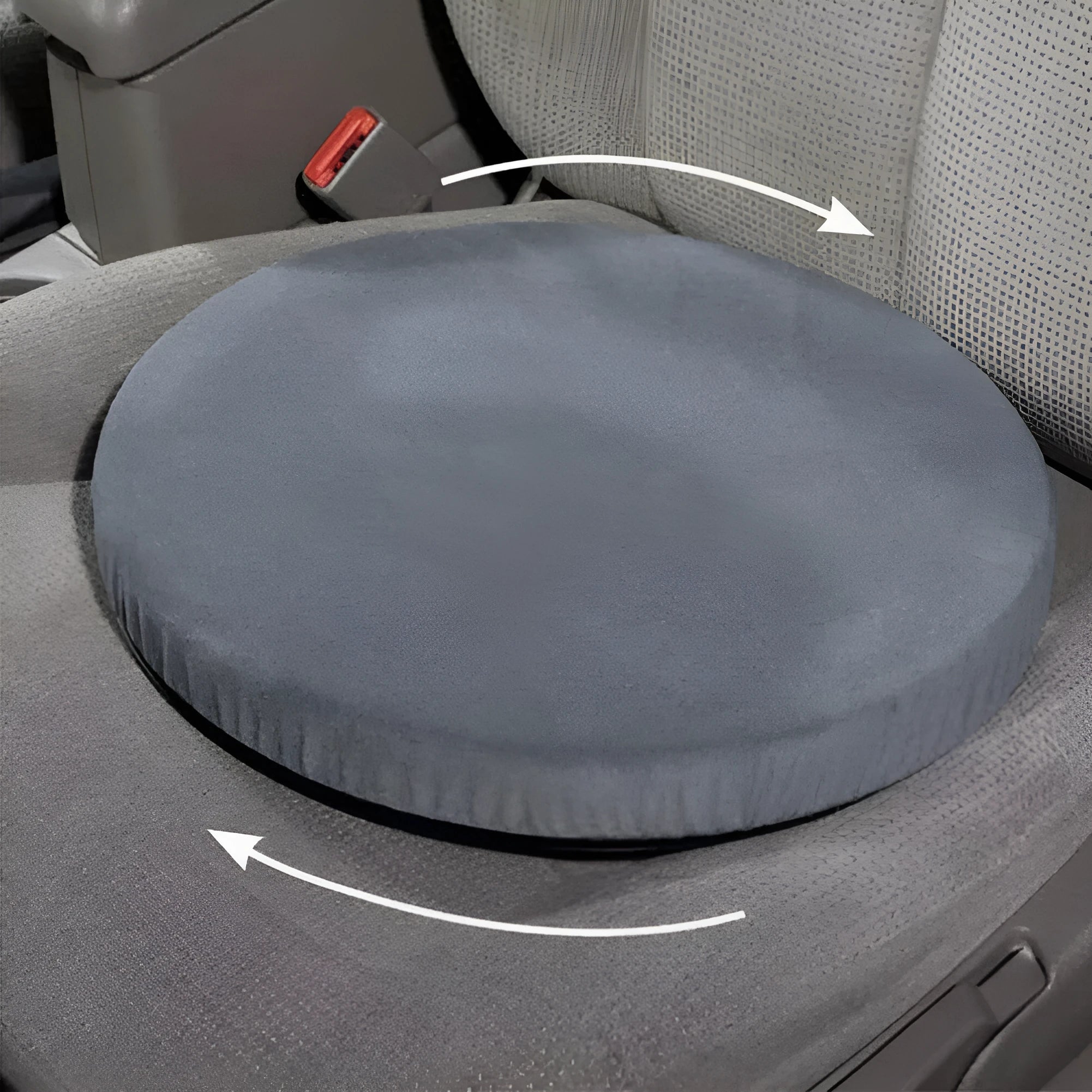 A grey rotating car seat cushion for lumbar support on a car seat.