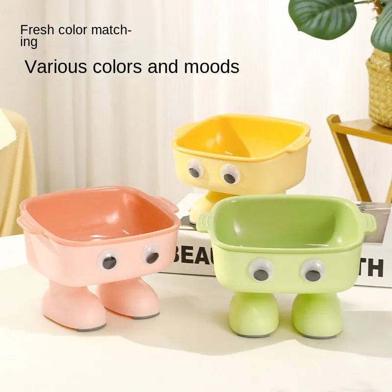 Green robot-shaped elevated cat bowl with tilted food surface and non-slip base