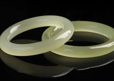 Natural ice silk jade round bar bracelet on a white background, showing its smooth texture and solid form.