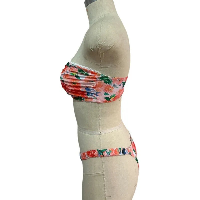 Floral printed lace bikini top in blue, shown as a sleeveless, backless tube top for swimming.