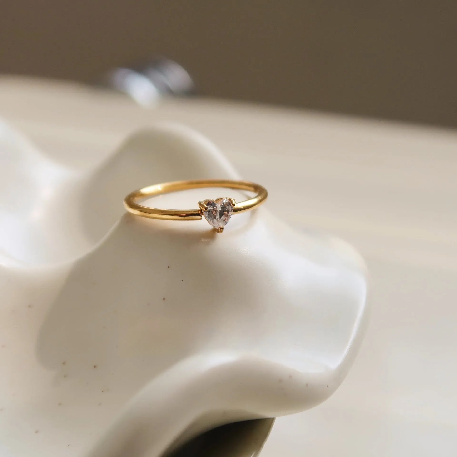 Simple golden electroplated stainless steel heart ring for women, shown in UK sizes 6, 7, 8.