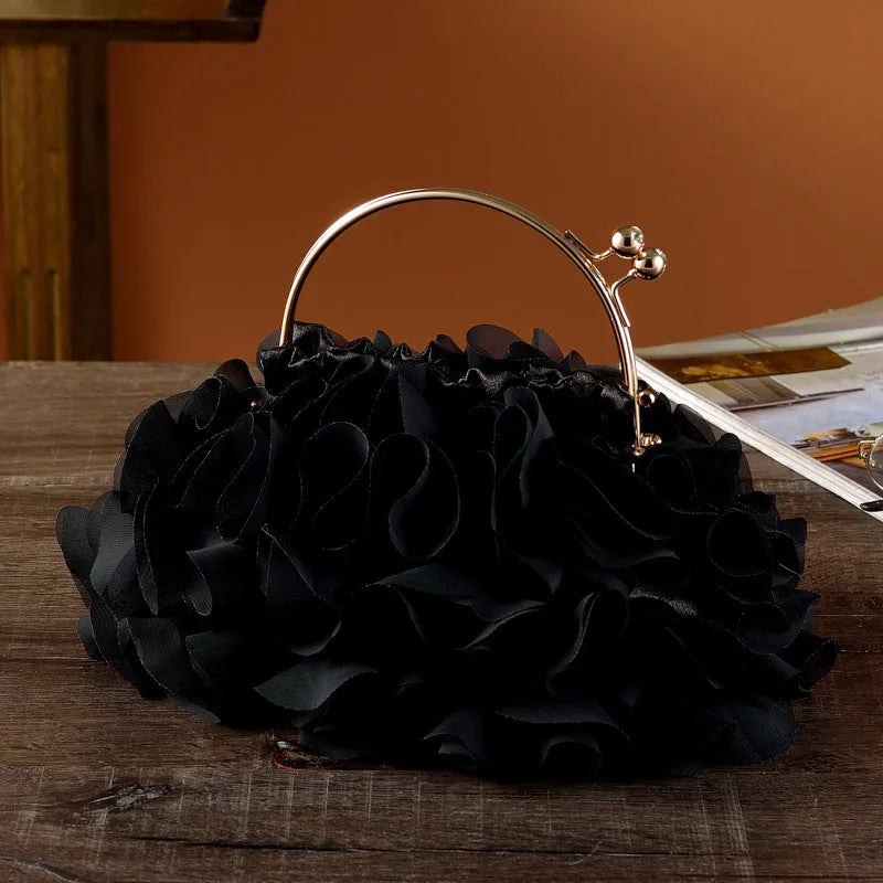 Handheld ladies' polyester banquet bag in soft dumpling shape with flower detail, black colour