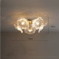 Modern white flower ceiling lamp with five heads emitting warm light, mounted on a ceiling.