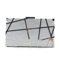 Women's small square glitter chain shoulder bag with lock closure, gold colour, on display