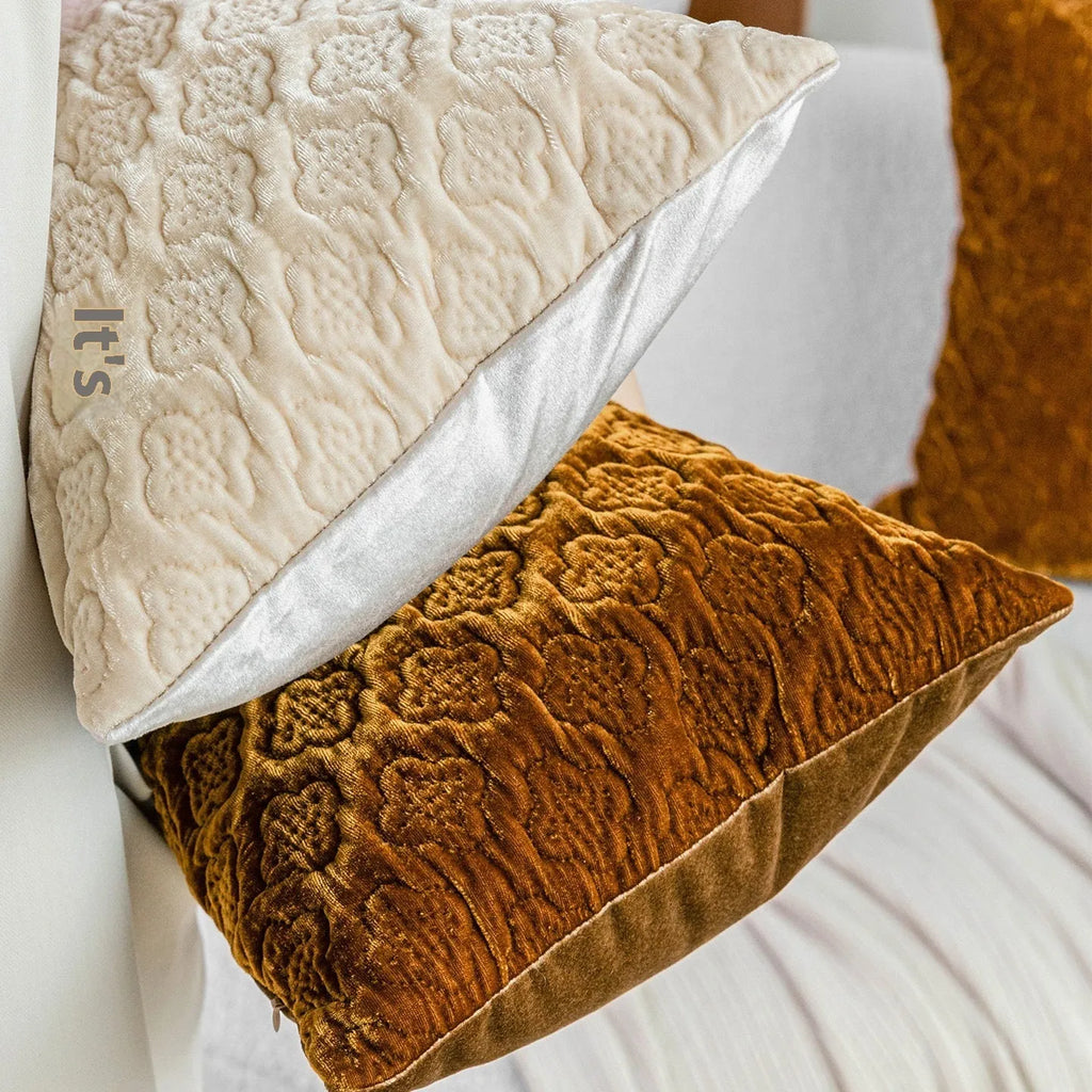 Brown gold antique style quilted square cushion with three-dimensional texture on a sofa.