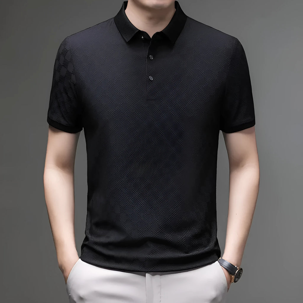 Man wearing a thin black V-neck t-shirt with a rhombus pattern and a side slit detail on the hem.
