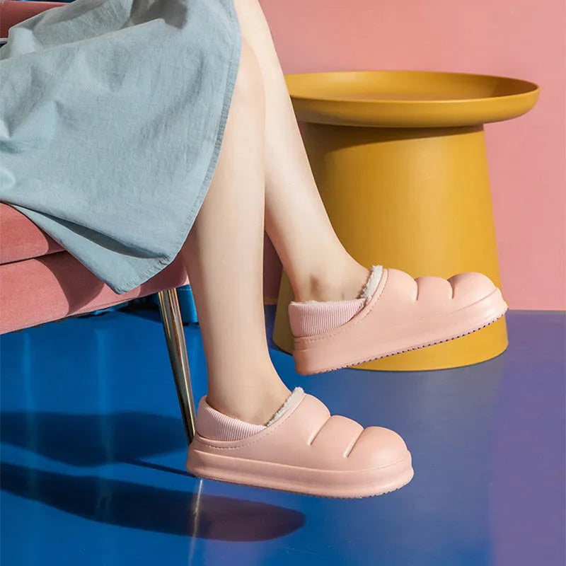 Women's winter slippers in green with plush lining and textured EVA sole, shown as sleeve-style overshoes.