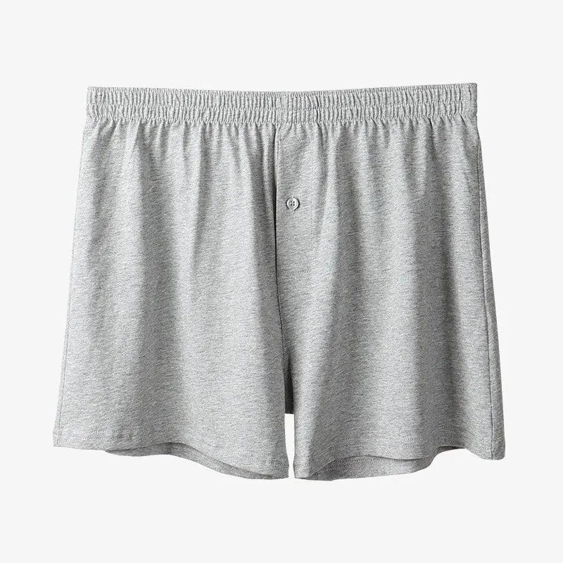Men's light grey high-waist cotton loose boxer shorts laid flat.