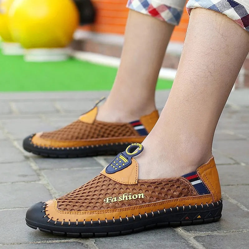 Men's brown mesh casual shoes with round toe and rubber sole on a plain background.