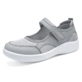 Women's low-top grey mesh casual trainers with Velcro fastening and a flat polyurethane sole.