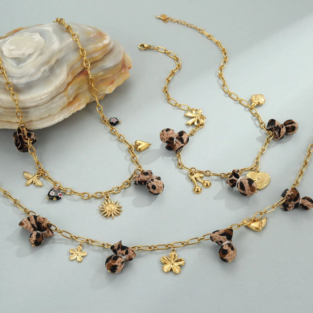Stainless steel necklace with a geometric leopard and love heart flower pendant on an adjustable chain.